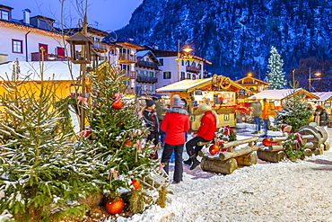 View of Christmas Market stalls at dusk in Campitello di Fassa, Val di Fassa, Trentino, Italy, Europe