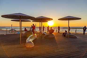 View of sunshades on promenade at sunset, Hayarkon Street, Tel Aviv, Israel, Middle East