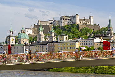 View of Hohensalzburg Castle and footbridge over Salzach River, UNESCO World Heritage Site, Salzburg, Austria, Europe