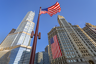 Early morning view of The Wrigley Building and Stars and Stripes US flag on DuSable Bridge, Chicago, Illinois, United States of America, North America