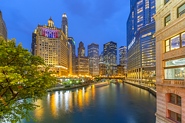 View of Chicago River and buildings illuminated at dusk, Chicago, Illinois, United States of America, North America