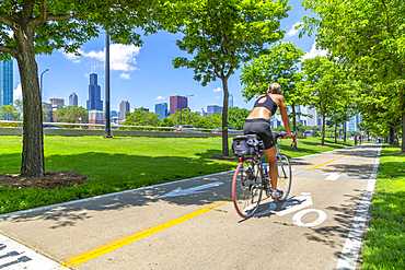 View of Chicago skyline and cyclist on South Lake Shore Drive, Chicago, Illinois, United States of America, North America