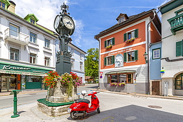 View of colourful buildings, red scooter and main street in Bad Aussie, Styria, Austria, Europe