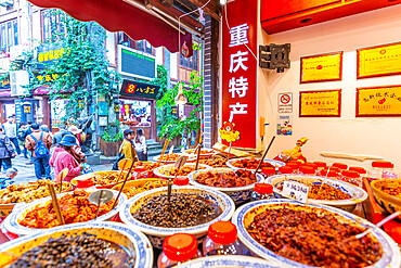 Busy shopping street and local food on display in Ciqikou Old Town, Shapingba, Chongqing, China, Asia