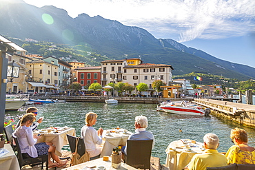 View of harbour and architecture on a sunny day, Malcesine, Lake Garda, Province of Verona, Veneto, Italian Lakes, Italy, Europe