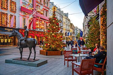 View of Christmas decorations, Christmas tree and shops on New Bond Street at Christmas, London, England, United Kingdom, Europe