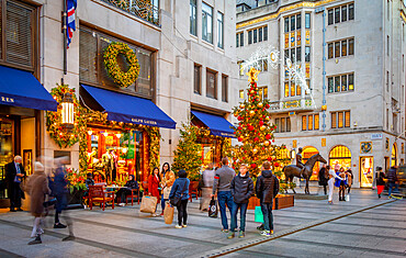 View of Christmas decorations, Christmas tree and shops on New Bond Street at Christmas, London, England, United Kingdom, Europe