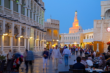 Souq Waqif looking towards the illuminated spiral mosque of the Kassem Darwish Fakhroo Islamic Centre, Doha, Qatar, Middle East