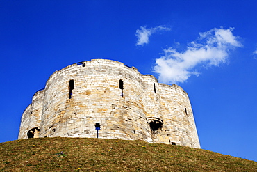 White clouds in blue sky above Cliffords Tower, City of York, Yorkshire, England, United Kingdom, Europe 