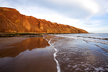 Carr Naze reflected on the wet sands, Filey Brigg, Filey, North Yorkshire, Yorkshire, England, United Kingdom, Europe