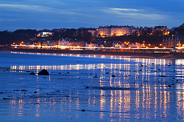 Seafront illuminations reflected on wet sands, Filey, North Yorkshire, England, United Kingdom, Europe