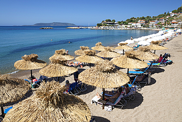 Umbrella-lined white sand beach with clear turquoise sea, Finikounda, Messenia, Peloponnese, Greece, Europe