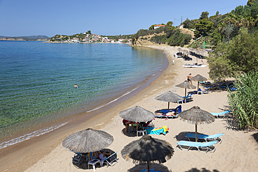 Umbrella-lined white sand beach with clear turquoise sea, Finikounda, Messenia, Peloponnese, Greece, Europe