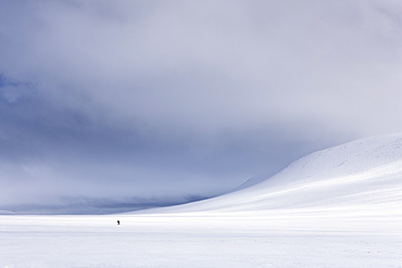 Lone figure skis across Rondane National Park, Norway, Scandinavia, Europe