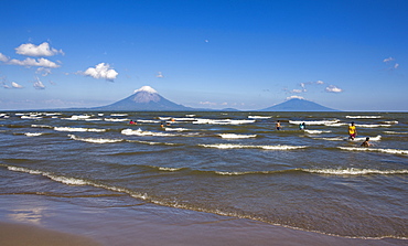 Ometepe Island and swimmers in Lake Nicaragua, Nicaragua, Central America