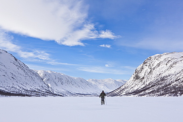 Skiing across a frozen lake in Mosstrond, near the Hardanger Plateau, Norway, Scandinavia, Europe