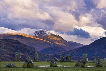 Castlerigg Stone Circle in autumn with the snow topped Helvellyn mountain range in the distance, Lake District National Park, Cumbria, England, United Kingdom, Europe