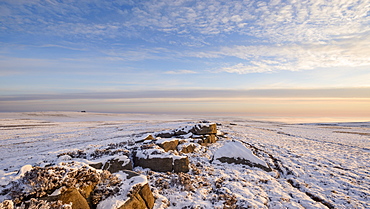 Glorious early morning light bathes the boulders and snow covered moor of Pockstones, with mist clearing in the Washburn Valley, North Yorkshire, Yorkshire, England, United Kingdom, Europe