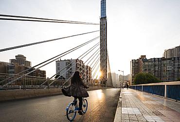 Sunrise behind modern bridge, Kunming, Yunnan Province, China, Asia