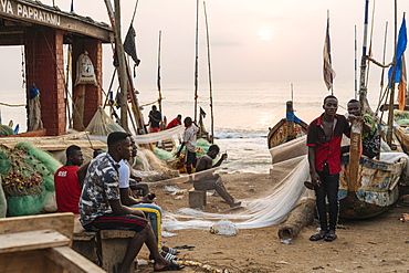 Fishermen fixing nets in Cape Coast, Ghana, Africa