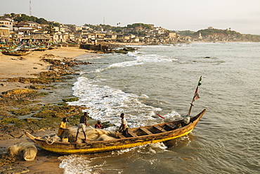 Fishermen with boats at dawn, Cape Coast, Ghana, Africa