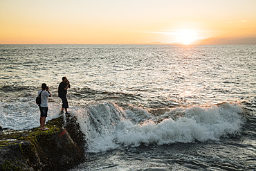 Tourists enjoying sunset at Tanah Lot Temple, Bali, Indonesia, Southeast Asia, Asia