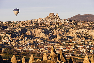 Hot air balloons flying among rock formations at sunrise in the Red Valley, Goreme National Park, UNESCO World Heritage Site, Cappadocia, Anatolia, Turkey, Asia Minor, Eurasia