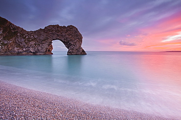 A colourful sunset over Durdle Door on the Jurassic Coast, UNESCO World Heritage Site, Dorset, England, United Kingdom, Europe