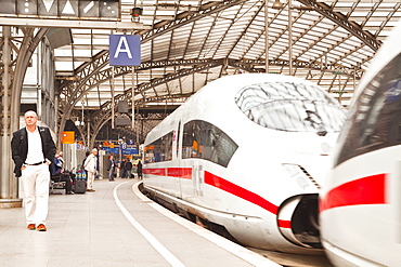 Passengers waiting to board a highspeed ICE train in Cologne railway station, North Rhine-Westphalia, Germany, Europe