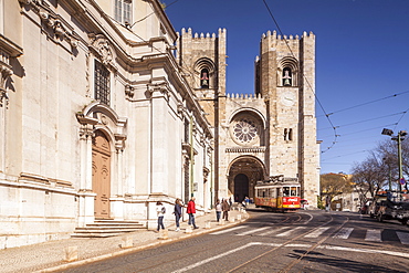 Tram 28 and Lisbon Cathedral (Se) dating from the 12th century and a mixture of architectural styles, Lisbon, Portugal, Europe