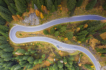 A view by drone of a winding road in the Dolomites, Veneto, Italy, Europe