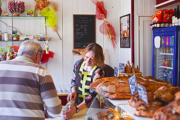 Customers are always greeted with a smile in the bakers at Lyons-la-Foret, Eure, Normandy, France, Europe