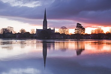 Salisbury Cathedral at dawn reflected in the flooded West Harnham Water Meadows, Salisbury, Wiltshire, England, United Kingdom, Europe