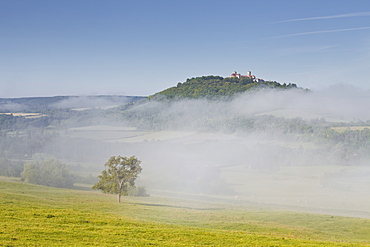 Mist clears away from around the hilltop village of Vezelay in the Yonne area of Burgundy, France, Europe