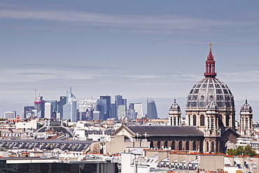 La Defense rising above the rooftops of Paris, France, Europe