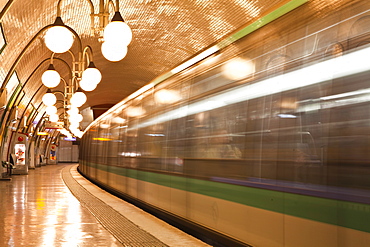 A Paris metro train leaves Cite station, Paris, France, Europe