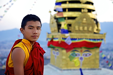 Young Buddhist monk at the Buddhist stupa of Swayambu (Monkey Temple) (Swayambhunath), UNESCO World Heritage Site, Kathmandu, Nepal, Asia