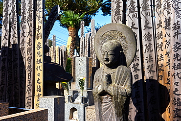 Buddah and wooden Toba tablets (memorial tablets) in a Japanese graveyard at Kyoji Buddhist Temple in Yanaka, Tokyo, Japan, Asia