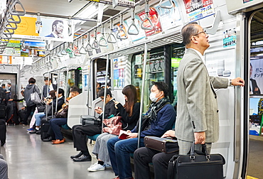 Passengers on a Tokyo subway train, Tokyo, Japan, Asia