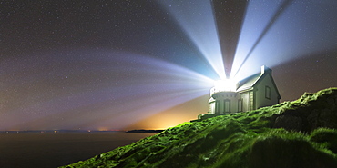 A home-built lighthouse at Pointe du Muller. Its light beams do not turn, but flash. They spread in the atmosphere in large light beams.