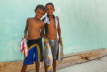 Children carrying Fishes - Grogos Island Maluku Indonesia