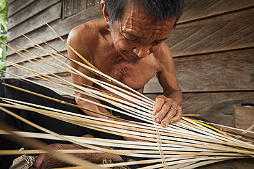 Man weaving a traditional fish basket - Borneo Indonesia