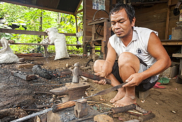 Man forging a traditional Dayak saber - Borneo Indonesia