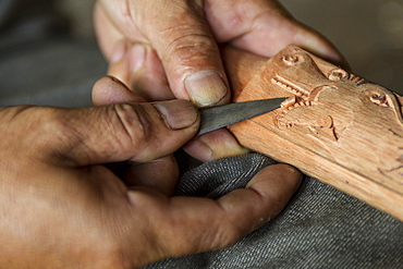 Man carving a traditional Dayak saber - Borneo Indonesia