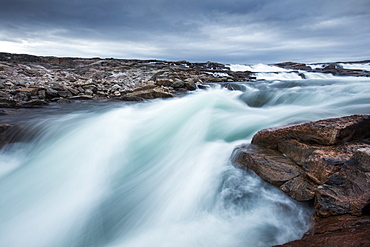 Blurred image of rushing waterfall near Bury Cove along west coast of Hudson Bay (Barren Coastline) 100 miles south of the Arctic Circle, Nunavut Territory, Canada