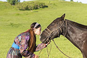 Mongolian woman with her horse, Bashang Grassland, Zhangjiakou, Hebei Province, Inner Mongolia, China