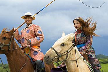 Mongol on a horse, with a catch lasso, Zhangjiakou, Bashang Grassland, Hebei Province, Inner Mongolia, China