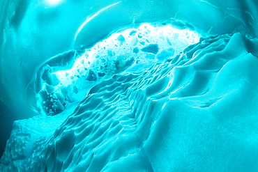 Only in springtime, when the hard winter slowly subsides, are the ice-cold waters suitable for divers who can dive around a iceberg that floats in crystal-clear water, Tasiilaq, East Greenland