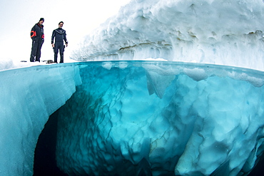 Split image of scuba divers before to dive under the ice, only in springtime, when the hard winter slowly subsides, are the ice-cold waters suitable for divers who can dive around a iceberg that floats in crystal-clear water, Tasiilaq, East Greenland