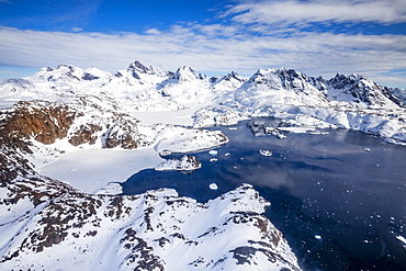 Panoramic view from helicopter, coast with mountains and sea, around Tasiilaq, East Greenland